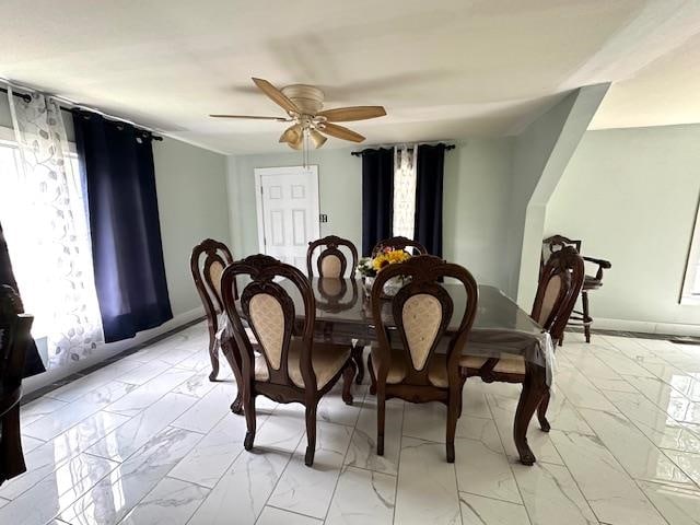 dining space featuring light tile patterned flooring and ceiling fan