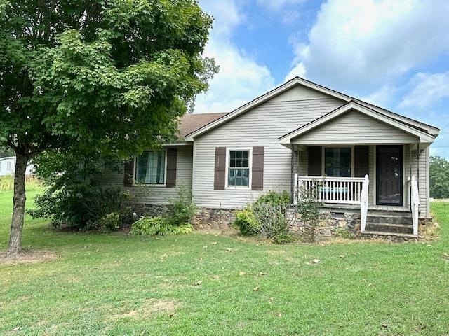 view of front of house with a porch and a front lawn