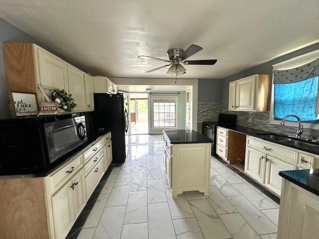 kitchen featuring light tile patterned floors, white cabinets, a kitchen island, ceiling fan, and backsplash