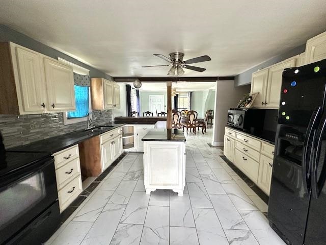 kitchen featuring black appliances, a center island, a wealth of natural light, and ceiling fan