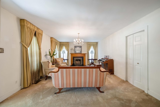 living room featuring light carpet, a fireplace, a notable chandelier, and baseboards