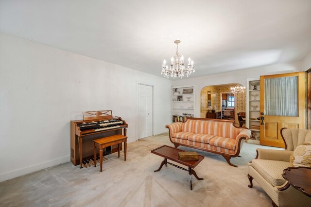 carpeted living room featuring a chandelier