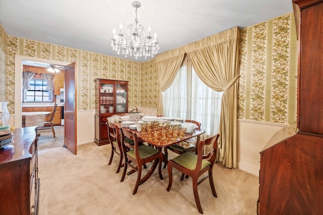 dining area featuring wainscoting, light carpet, and wallpapered walls