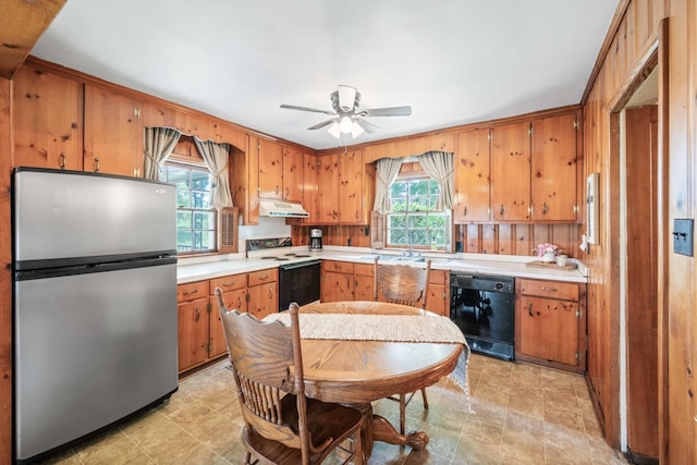 kitchen featuring dishwasher, light countertops, range with electric stovetop, and freestanding refrigerator