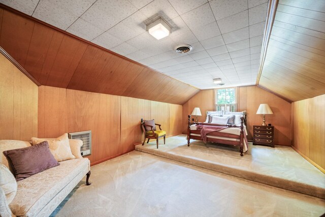 carpeted bedroom featuring wood walls and lofted ceiling