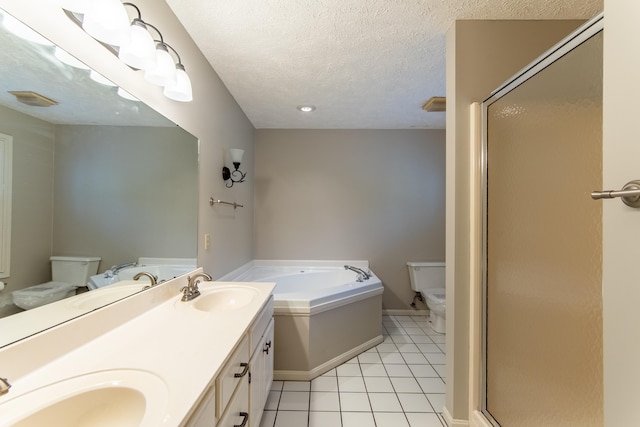 full bathroom with tile patterned flooring, vanity, a textured ceiling, shower with separate bathtub, and toilet