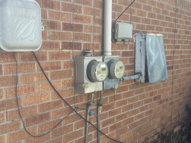 details with electric meter and brick siding