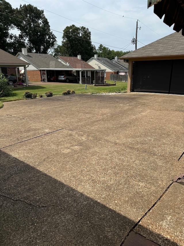 view of yard with a carport, an outdoor structure, and a garage