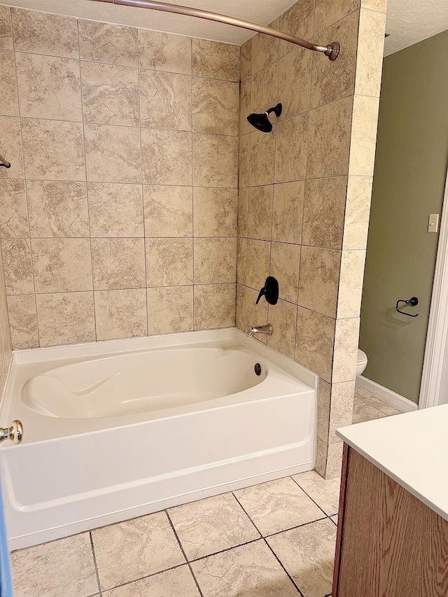 full bathroom featuring vanity, a textured ceiling, toilet, and tiled shower / bath