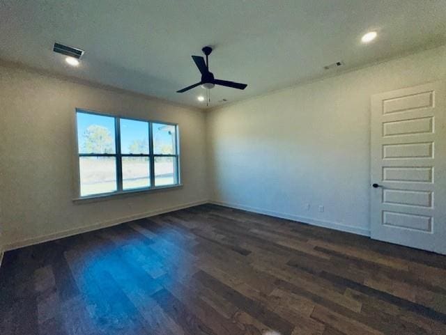 empty room with dark wood-type flooring, recessed lighting, visible vents, and baseboards