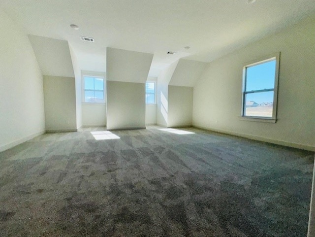 bonus room with lofted ceiling, carpet, visible vents, and baseboards