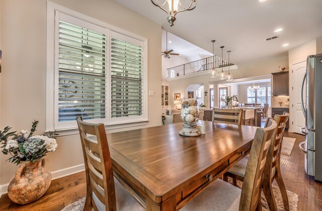 dining space featuring dark hardwood / wood-style floors, plenty of natural light, and a chandelier