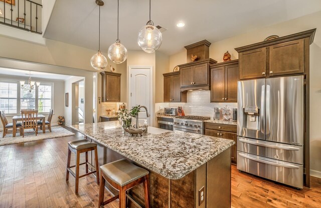 dining space featuring dark hardwood / wood-style flooring and ceiling fan with notable chandelier