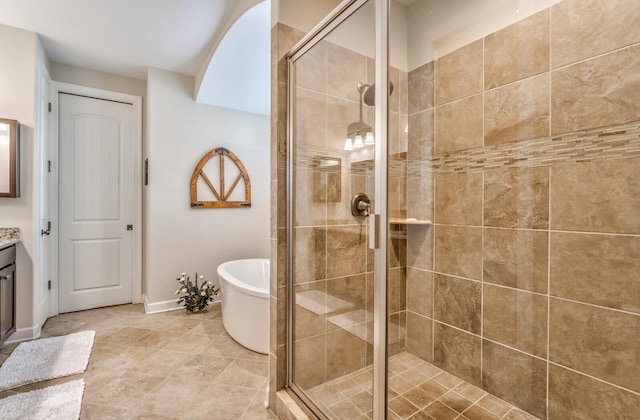 bathroom featuring tile patterned floors, separate shower and tub, and vanity