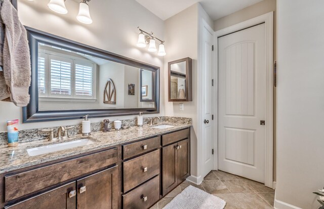 bathroom with dual vanity and tile patterned floors