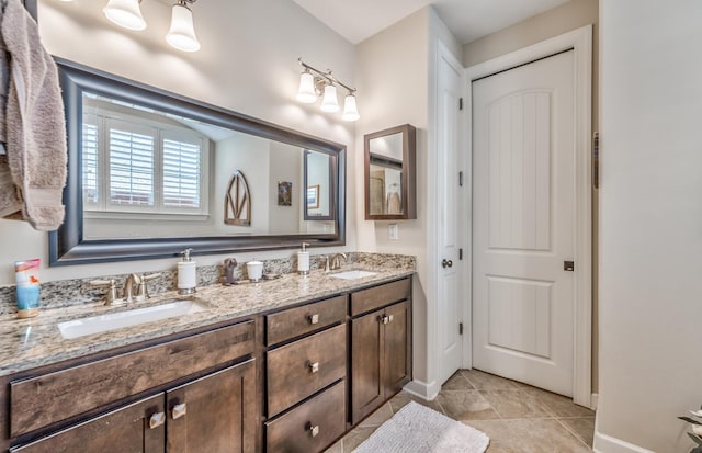 bathroom featuring tile patterned flooring and vanity