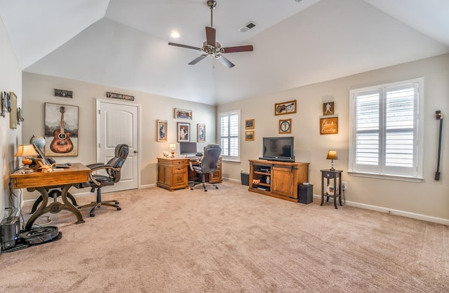 office with ceiling fan, plenty of natural light, vaulted ceiling, and light carpet