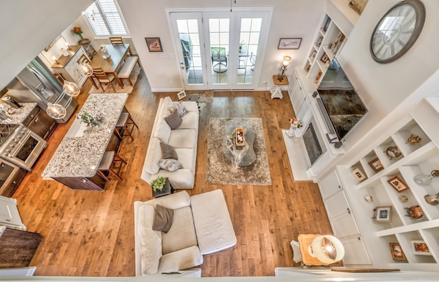 living room with hardwood / wood-style flooring and built in features