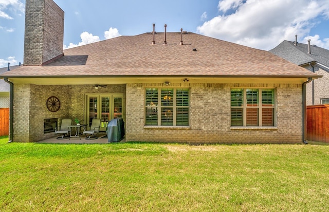 rear view of house with a yard, ceiling fan, and a patio area