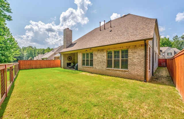 rear view of house featuring a lawn