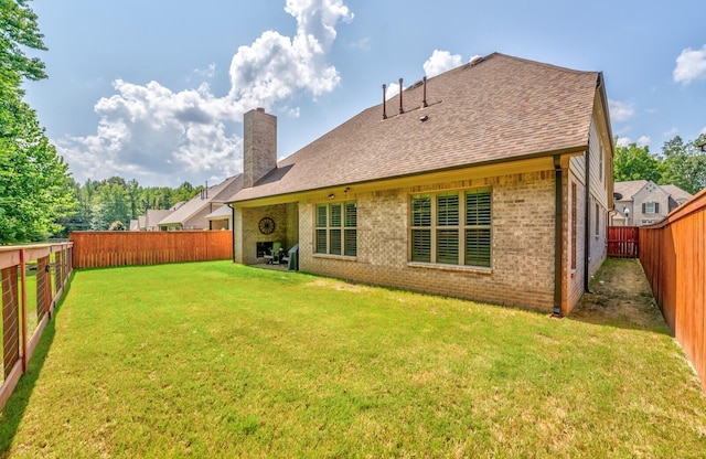 rear view of house with a yard