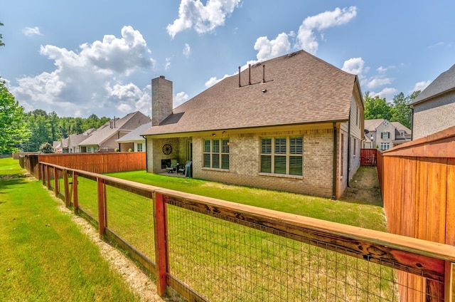 back of property featuring a lawn