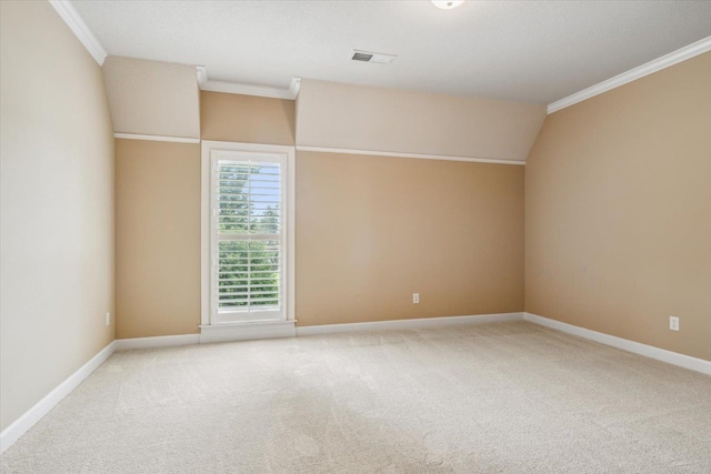 unfurnished room featuring crown molding, lofted ceiling, and carpet flooring