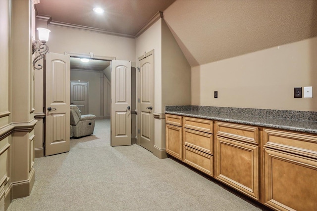 interior space featuring crown molding, vaulted ceiling, and light carpet