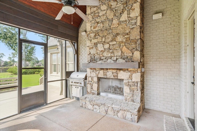 unfurnished living room with lofted ceiling, ceiling fan, a fireplace, wooden ceiling, and light colored carpet