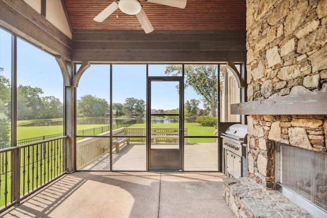 unfurnished sunroom featuring lofted ceiling, wooden ceiling, and ceiling fan