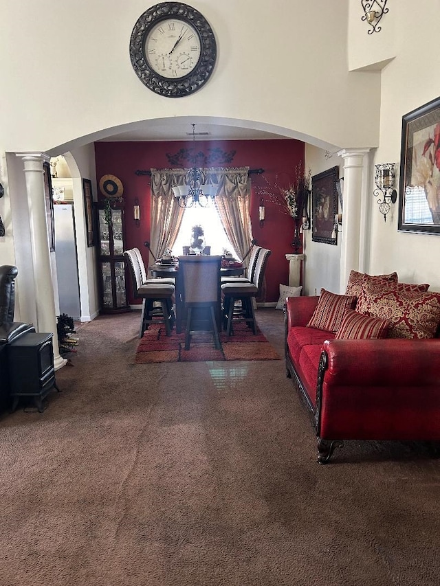 dining room with decorative columns, a high ceiling, and arched walkways