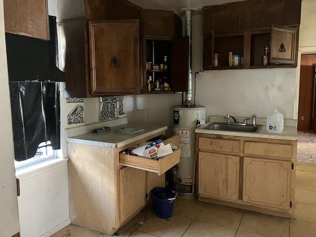 kitchen with backsplash, light tile patterned floors, sink, and gas water heater