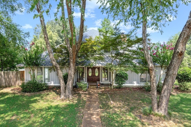 obstructed view of property with a front lawn