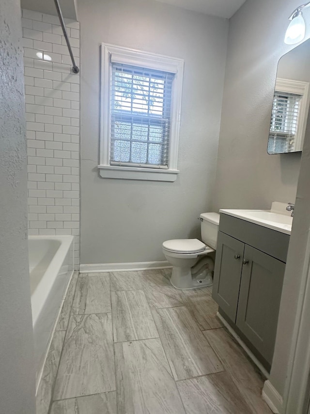 full bathroom featuring vanity, toilet, and tiled shower / bath combo