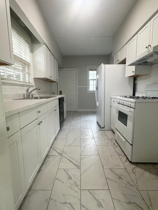 kitchen with sink, dishwasher, white cabinets, decorative backsplash, and white gas stove