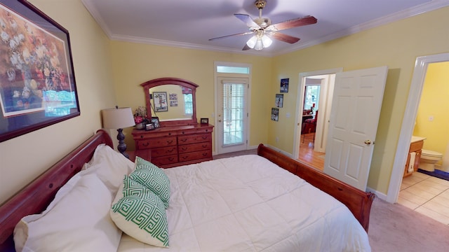 bedroom featuring carpet, crown molding, a ceiling fan, ensuite bath, and baseboards