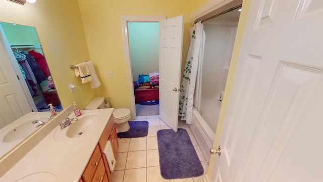 full bath featuring toilet, vanity, and tile patterned floors