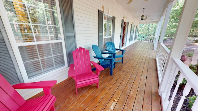 wooden deck with a porch and a ceiling fan