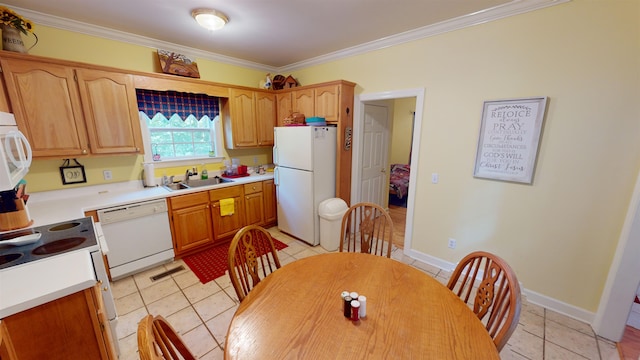 kitchen featuring white appliances, ornamental molding, light countertops, and a sink