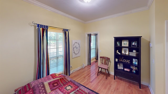 bedroom with light wood finished floors, ornamental molding, and baseboards