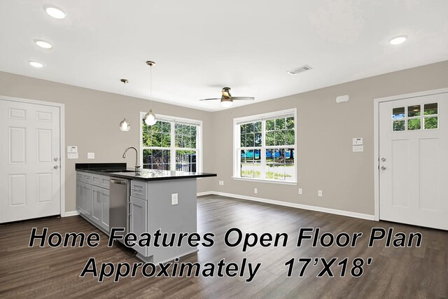 kitchen featuring dark wood-type flooring, pendant lighting, ceiling fan, sink, and kitchen peninsula