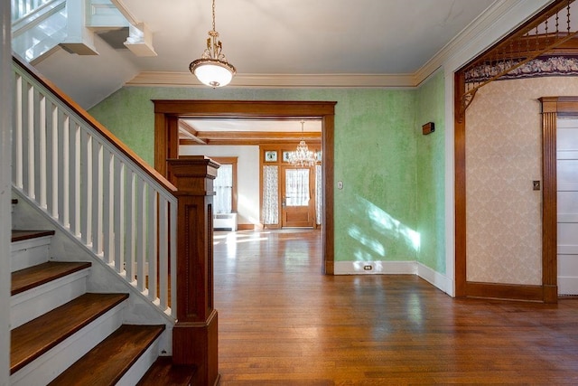 entryway with crown molding, stairway, wood finished floors, and wallpapered walls