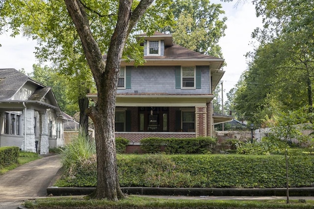 american foursquare style home featuring brick siding