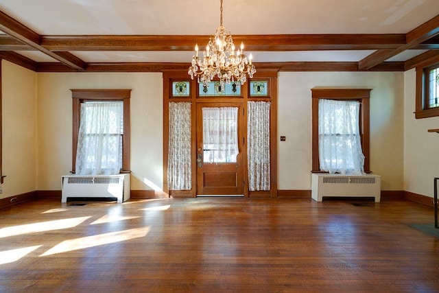 entryway with baseboards, a healthy amount of sunlight, wood finished floors, and radiator