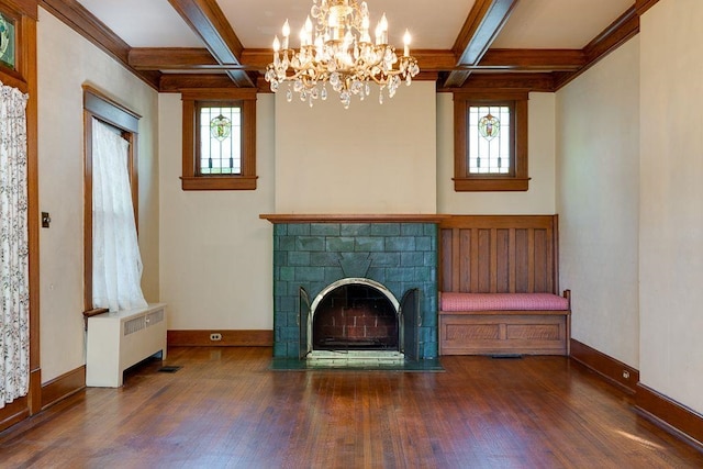 unfurnished living room with a fireplace with flush hearth, radiator heating unit, wood finished floors, and a wealth of natural light