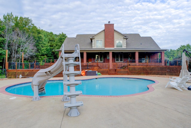 view of pool featuring a wooden deck and a water slide