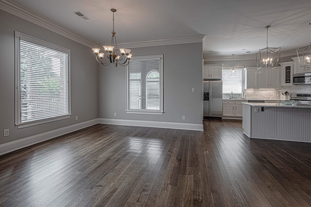 kitchen featuring appliances with stainless steel finishes, plenty of natural light, white cabinets, and dark hardwood / wood-style floors