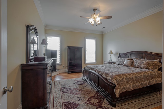 bedroom featuring light hardwood / wood-style flooring, ceiling fan, and ornamental molding