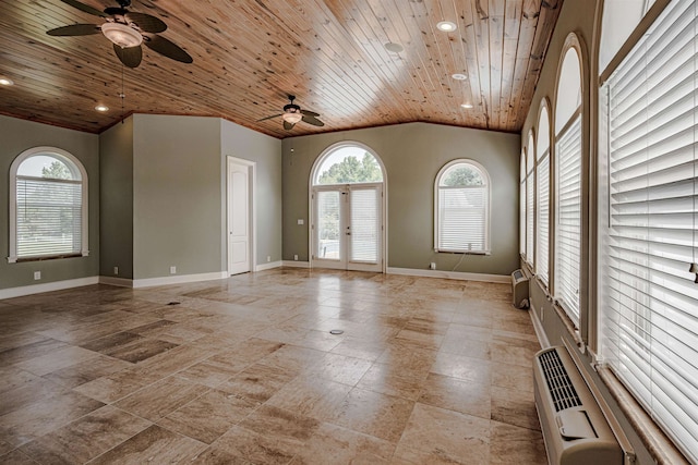 tiled empty room with ceiling fan, a high ceiling, wooden ceiling, and french doors