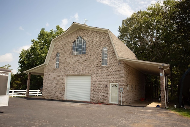 view of side of property with a carport and a garage